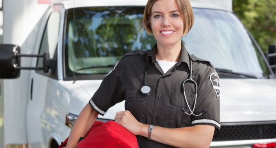 fire fighter in uniform holding fire hose standing next to a fire truck