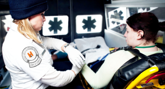Female paramedic student working on a patient