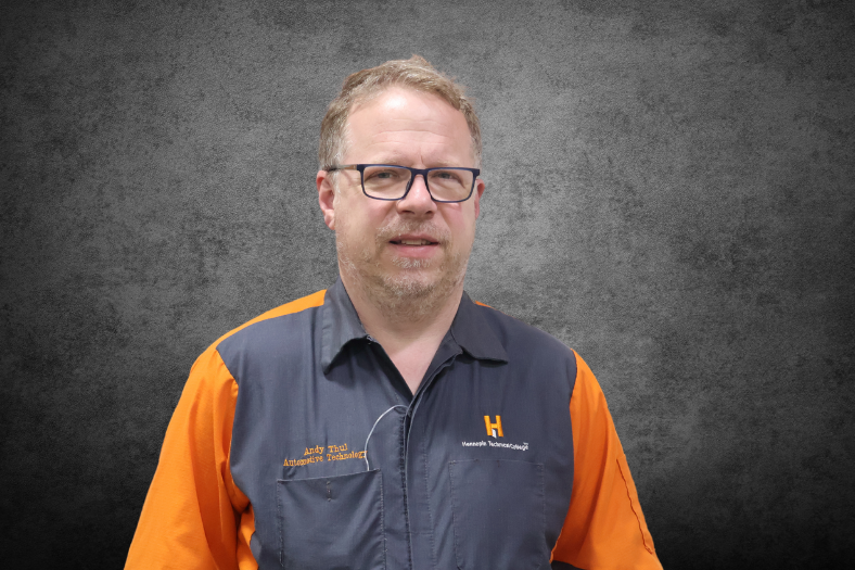 A headshot photo of Andrew Thul on a gray background. A headshot photo of Andrew Thul on a gray background.